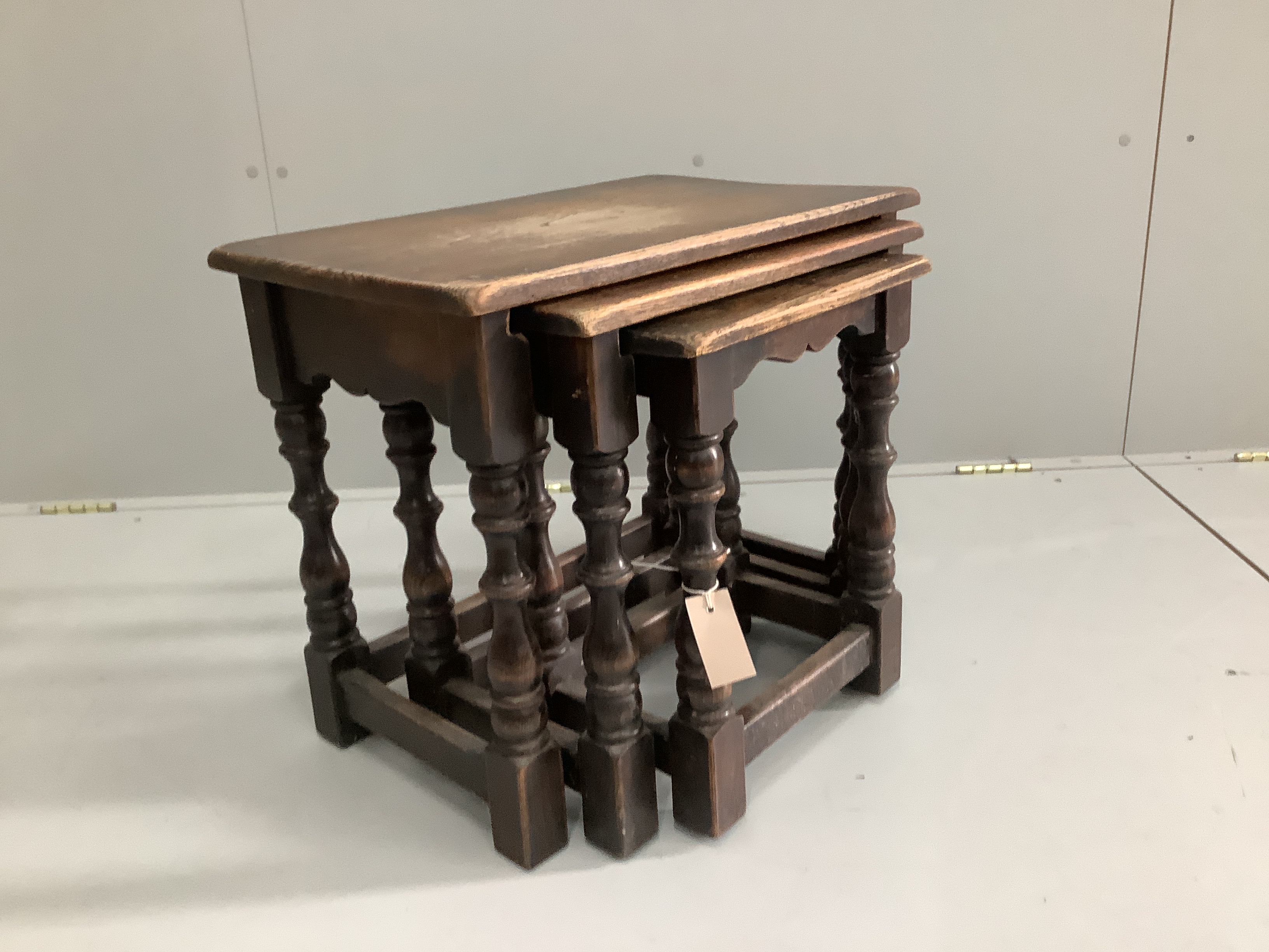 A nest of three 18th century style rectangular oak tea tables, width 55cm, depth 34cm, height 48cm